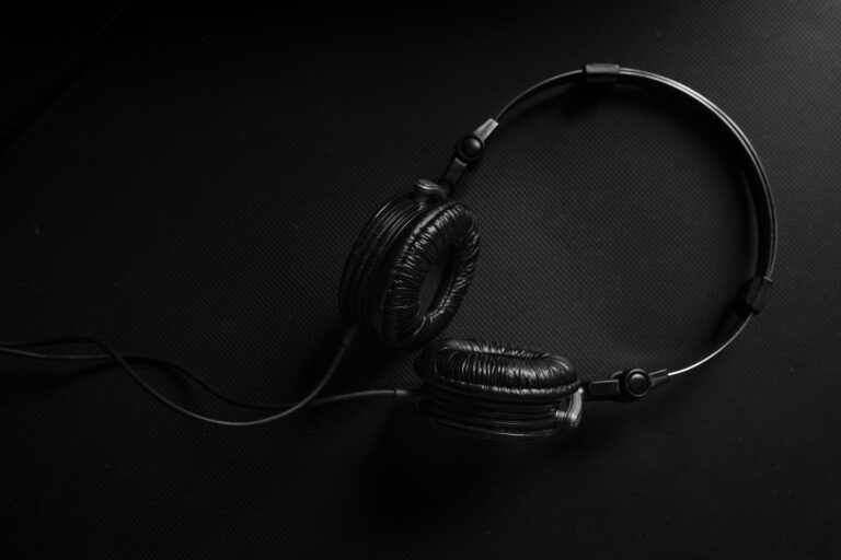 Minimalist black headphones on a dark textured background, ideal for audio and music design themes.